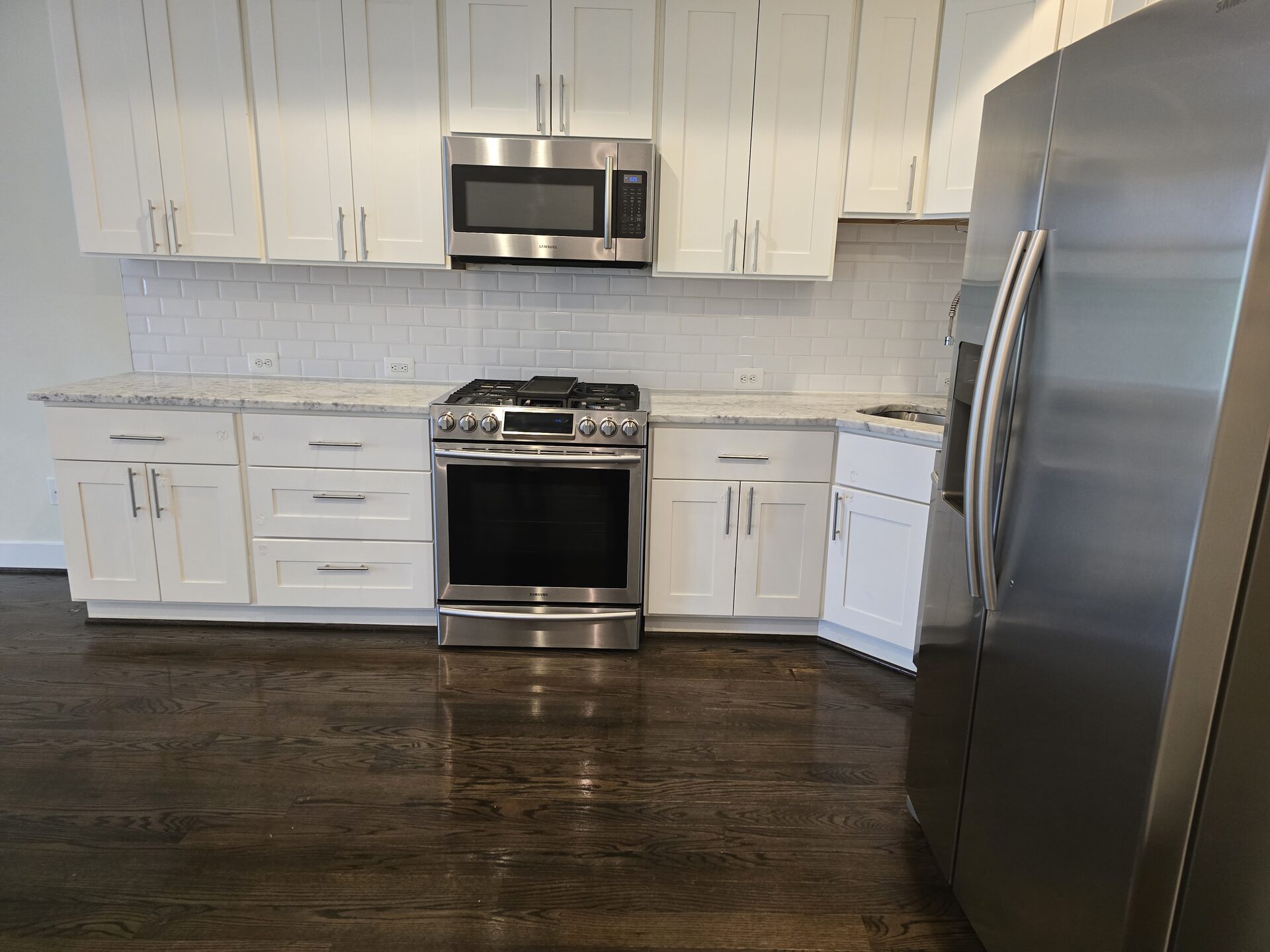 Modern kitchen with white cabinets cleaned by Lorena's Cleaning